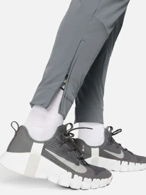 Брюки NIKE DRI-FIT UNLIMITED TAPERED LEG модель FB7548-084 Фото