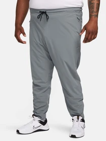 Брюки NIKE DRI-FIT UNLIMITED TAPERED LEG модель FB7548-084 Фото