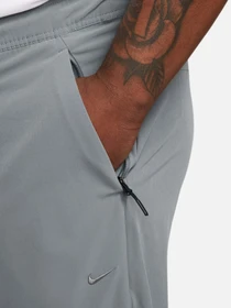 Брюки NIKE DRI-FIT UNLIMITED TAPERED LEG модель FB7548-084 Фото