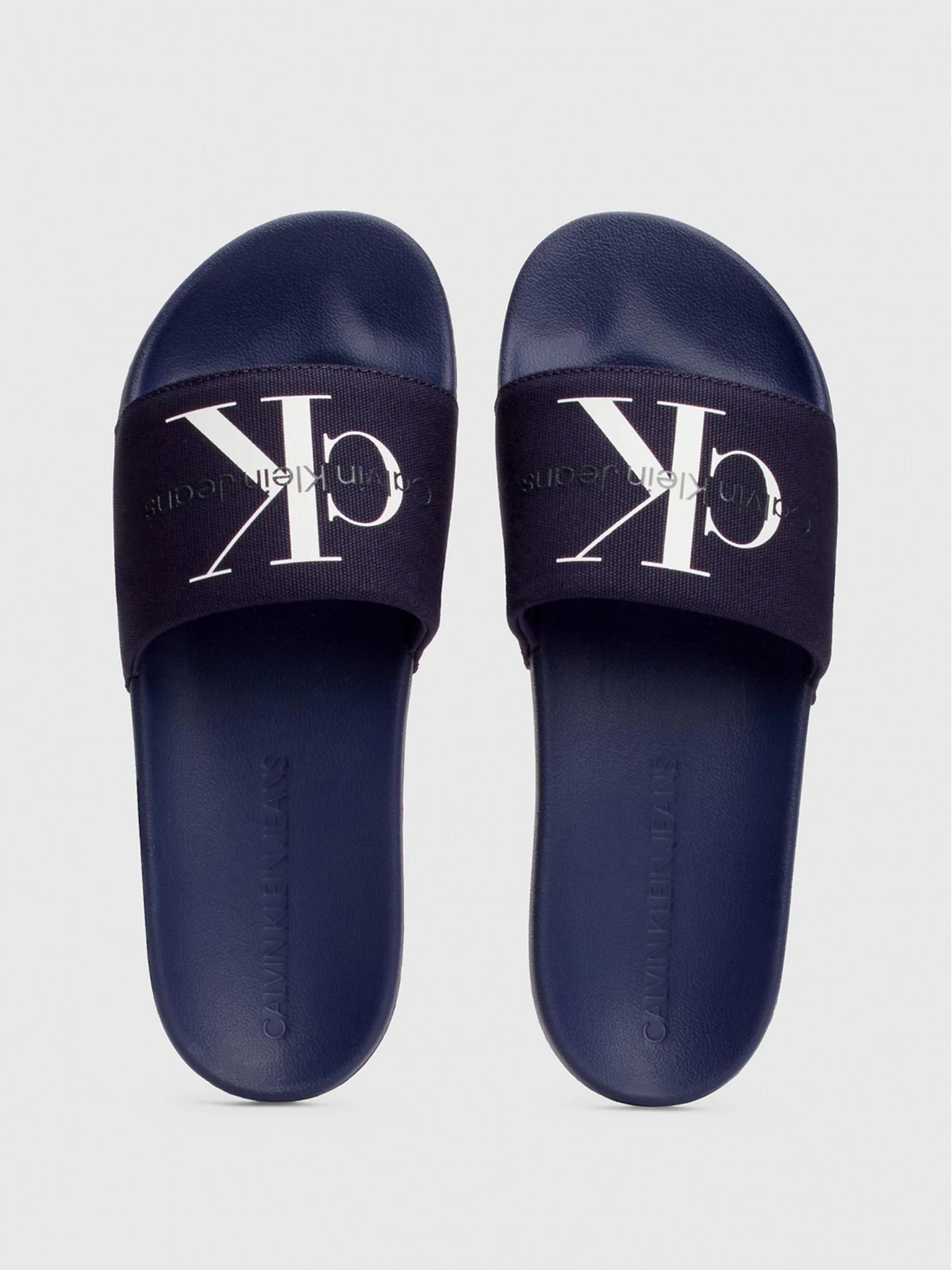Шльопанці Calvin Klein Slide Monogram Co модель YM0YM00061-0GY Фото