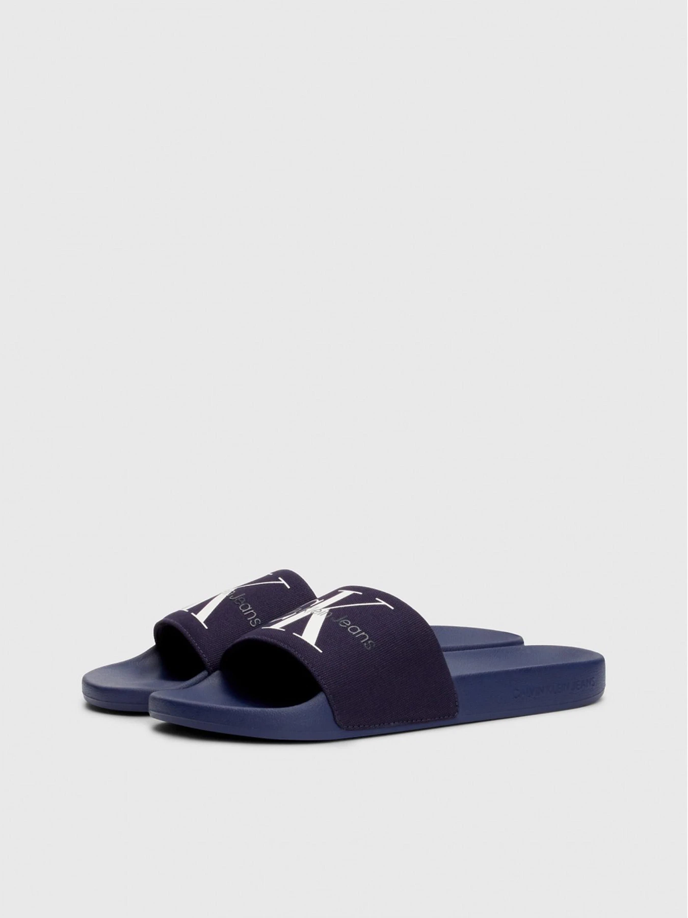 Шльопанці Calvin Klein Slide Monogram Co модель YM0YM00061-0GY Фото