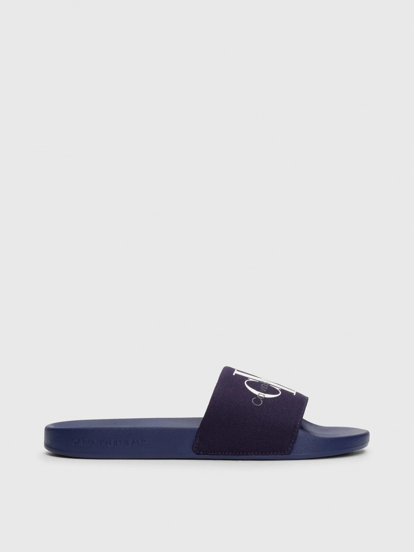 Шльопанці Calvin Klein Slide Monogram Co модель YM0YM00061-0GY Фото
