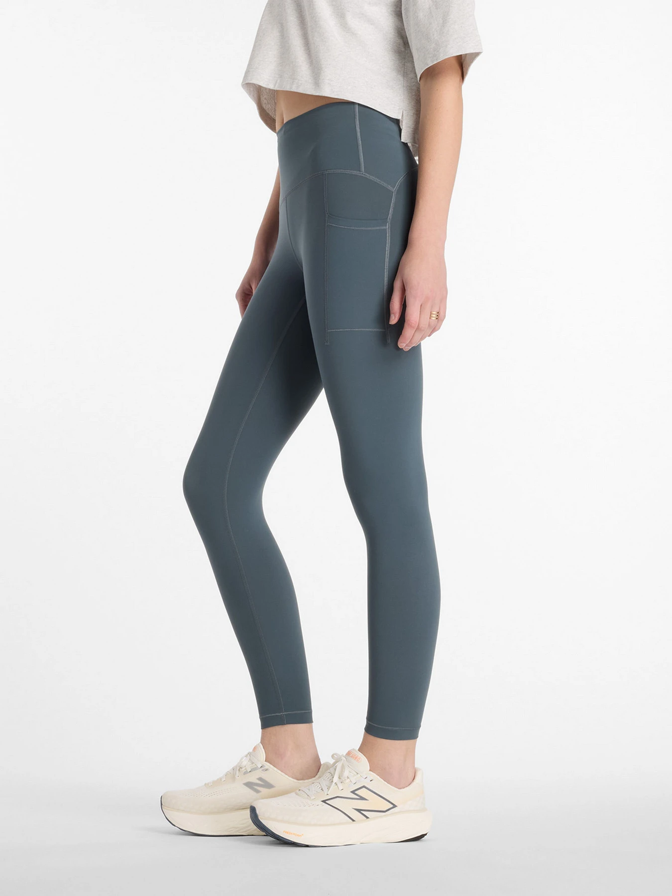 Брюки New Balance NB Sleek Pocket High Rise Legging 25" модель WP51268GT Брюки New Balance NB Sleek Pocket High Rise Legging 25" модель WP51268GT Фото